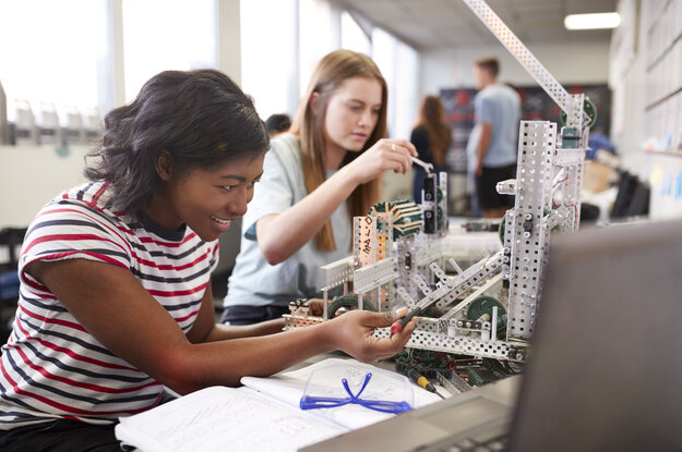 Zwei junge Frauen bauen eine Maschine in Robotik.